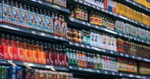 Shelves of sodas and non-alcoholic beverages in a grocery store aisle