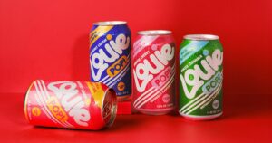 Four cans of Louie POP! soda—Blackberry Lemon, Hibiscus Cherry, Ginger Cucumber, and Strawberry Lemon—on a red background.